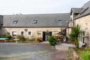 a brick building with a patio in front of it at Domaine de Kerroux in Bannalec