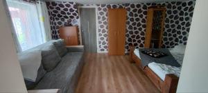 a living room with a couch and a table at Ligzdas in Valgalciems