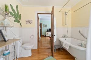 a bathroom with a tub and a toilet and a sink at Alicion Bed & Breakfast in Lunenburg +30 photos