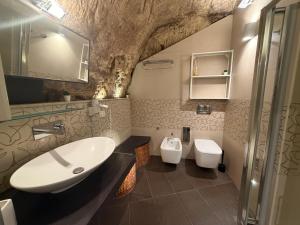 a bathroom with a sink and a toilet at CasaCastellett in Modica