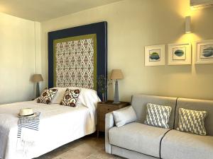a bedroom with a bed and a couch at Loggos Harbour Suites in Longós