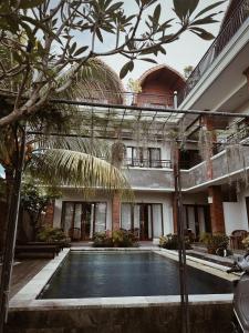 a courtyard of a building with a swimming pool at 21REDA Cozy Stay in Uluwatu