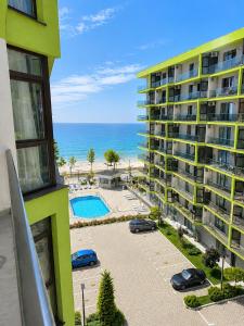an apartment building with a parking lot and the ocean at Alezzi Beach Resort Pool &Spa in Mamaia Sat/Năvodari