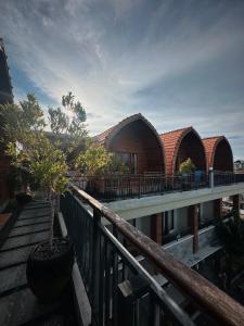 a building with two domes and a tree on a balcony at 21REDA Cozy Stay in Uluwatu