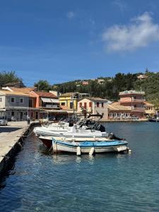 two boats are docked at a dock in the water at Loggos Harbour Suites in Longós