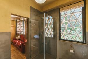 a bathroom with a shower with a glass door at La Pimpinella di Semifonte in San Donnino +62 photos