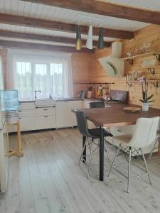 a kitchen with a large wooden table and chairs at Family vacations house in Tīnūži