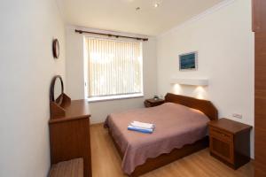 a small bedroom with a bed and a window at Large apartment by the Opera- luxury living room, 2 bedrooms, equipped kitchen and balcony in Yerevan