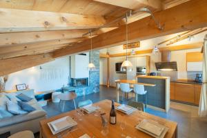 a living room with a couch and a table at Appartement Corniche - MultiPass in Les Gets