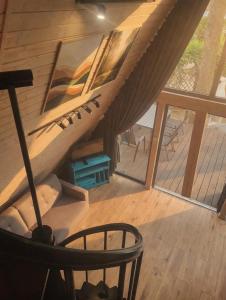 a wooden staircase in a house with a window at Strefa Czasu Skorzęcin in Skorzęcin