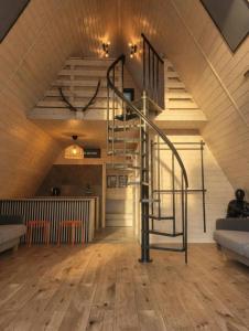 a staircase in the middle of a room with wooden floors at Strefa Czasu Skorzęcin in Skorzęcin