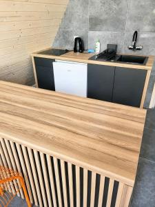 a kitchen with a wooden counter with a sink at Strefa Czasu Skorzęcin in Skorzęcin
