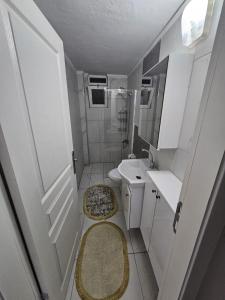 a small bathroom with a toilet and a sink at Paradise Garden sitesi 3 oda havuzlu eşyalı daire kişi fiyatı değil oda fiyatı in Side +11 photos