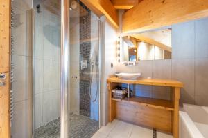 a bathroom with a sink and a shower at Appartement Corniche - MultiPass in Les Gets +23 photos