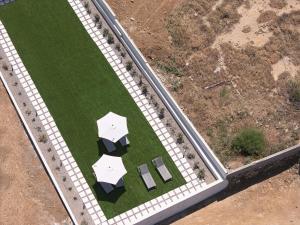 an overhead view of a golf course with umbrellas at MGM Suites in Panormos Rethymno
