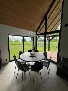 a dining room with a round table and chairs at Mihkliranna Puhkemaja in Marksa