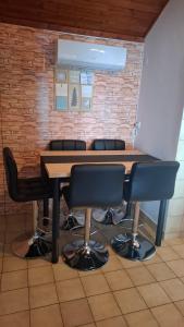 a table and chairs in a room with a brick wall at Apartments Drazen in Crikvenica