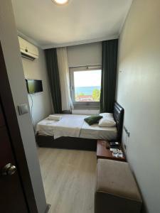 a small bedroom with a bed and a window at Ganita Life Hotel in Trabzon