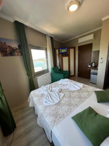 a hotel room with two beds and a window at Ganita Life Hotel in Trabzon