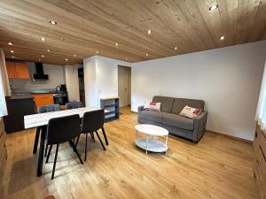 a living room with a couch and a table at CAPRICE 4 - Appartement centre village et proche pistes in La Clusaz