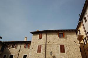 un ancien bâtiment en pierre avec un ciel bleu en arrière-plan dans l'établissement Residenza I Due Mondi, à Spolète