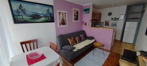 a small living room with a couch and a table at Apartman Ograde in Bosanski Novi