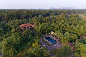 an aerial view of a house on a hill in the forest at Samode Safari Lodge in Parāsi