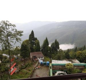 a view of a village with mountains in the background at Ang Ds Homestay in Sonāda