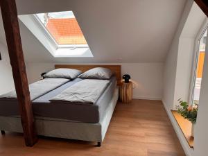 a bedroom with two beds and a skylight at hirsch APARTEMENTS in Rheine
