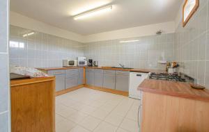 a large kitchen with white appliances and wooden counters at Le gite de la cea in Saint-Mards-en-Othe +6 photos