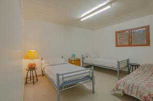 a room with two beds and a lamp in it at Le gite de la cea in Saint-Mards-en-Othe