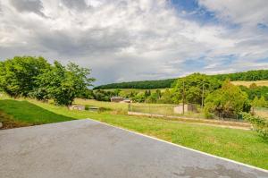 an empty driveway with a view of a field at Le gite de la cea in Saint-Mards-en-Othe