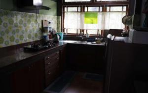 a kitchen with a sink and a window at Ang Ds Homestay in Sonāda