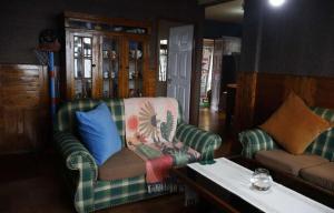 a living room with two couches and a table at Ang Ds Homestay in Sonāda +13 photos