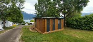a tiny house on the side of a road at Camping Onlycamp Au Cœur du Lac - Lac d'Annecy in Sévrier