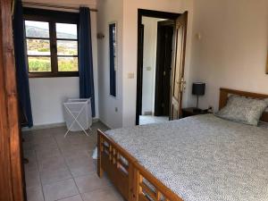 a bedroom with a large bed and a window at Bella Vista - Finca Tabaiba in Icod de los Vinos
