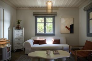 a living room with a couch and a table at Porto Kea Suites by Sandglass in Korissia