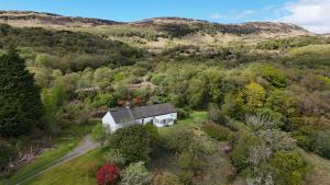 an aerial view of a house in a forest at Cove Cottage Ellary in Lochgilphead +9 photos