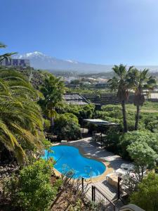 a resort with a swimming pool and palm trees at Bella Vista - Finca Tabaiba in Icod de los Vinos