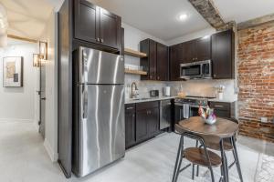 a kitchen with a stainless steel refrigerator and a table at Park Hotel 2BR Suite 306 in Chattanooga