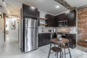 a kitchen with a stainless steel refrigerator and a table at Park Hotel 2BR Suite 306 in Chattanooga +37 photos