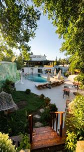 a patio with benches and tables and a swimming pool at Taga Hotel in Bitez