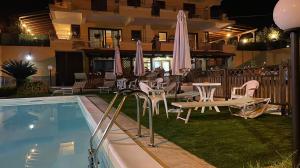 a patio with a table and chairs and a pool at Villa Mare e Monti in Trivio