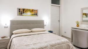 a white bedroom with a large bed and a sink at Villa Mare e Monti in Trivio