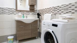 a bathroom with a washing machine and a sink at Villa Mare e Monti in Trivio