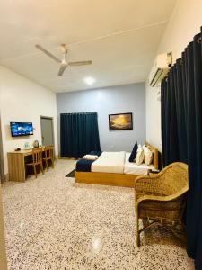 a hotel room with a bed and a desk at Urban Villa in Guwahati