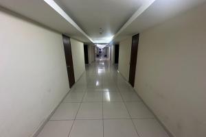 an empty hallway of an office building with a long corridor at Ain Studio Apartment in Kota Bharu
