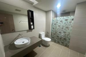 a bathroom with a sink and a toilet and a shower at Ain Studio Apartment in Kota Bharu