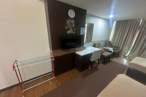 a living room with a couch and a tv at Ain Studio Apartment in Kota Bharu +10 photos