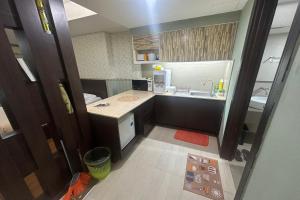 a small kitchen with a sink and a counter at Ain Studio Apartment in Kota Bharu